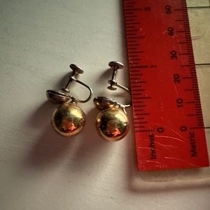Gold tone clip earrings.